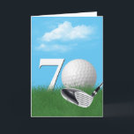 70th Birthday Golf Ball In Grass Card<br><div class="desc">A white golf ball in green grass with a golf club,  blue sky,  and clouds for 70th birthday.</div>