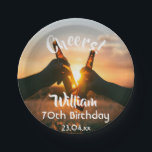 70th birthday party guys cheers beer paper plate<br><div class="desc">A paper plate for a 70th birthday party for a guy. Photo of two hands holding bottles of beer against the evening sunset. Keep the photo or add yours. With the text: Cheers to, templates for a name age 70 and a date. Date of birth or the date of the...</div>