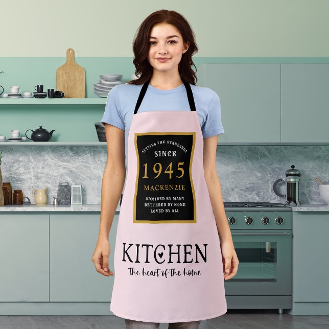 80th Birthday Kitchen Queen Heart Of Home Pink Apron (Personalized 80th birthday pink apron worn by a woman in the kitchen)