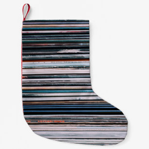 A background consisting of a stack of records in t small christmas stocking