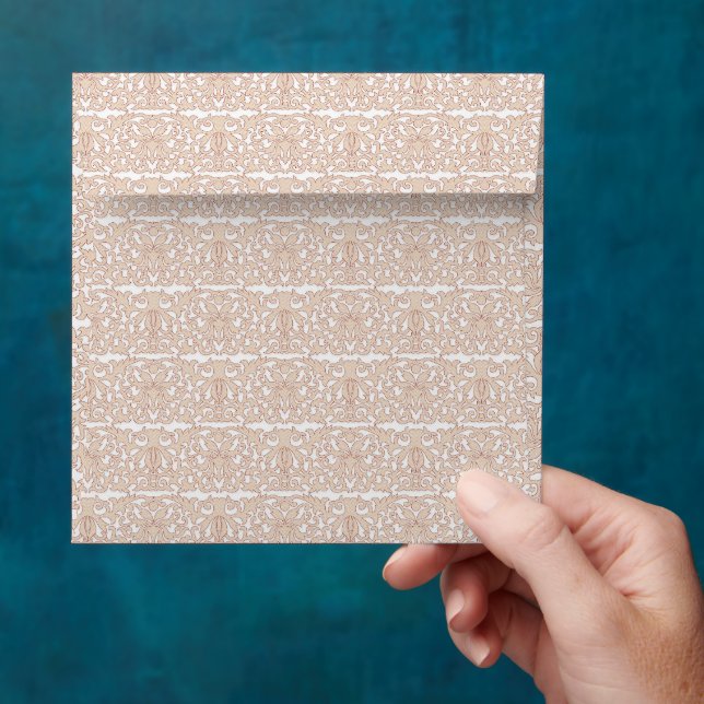 a beige and white chequered pattern on a white bac envelope (Hand)