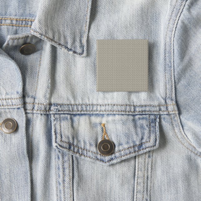 a beige background with a pattern of small squares 15 cm square badge (In Situ)