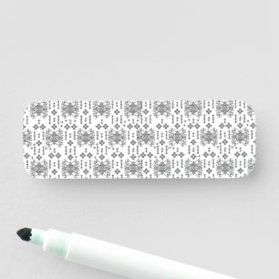 a black and white pattern with a white background name tag