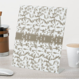 a black and white photo of a pattern pedestal sign