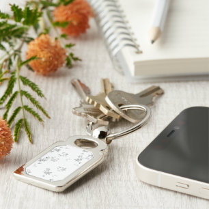 a black and white photo of bubbles on a white back key ring