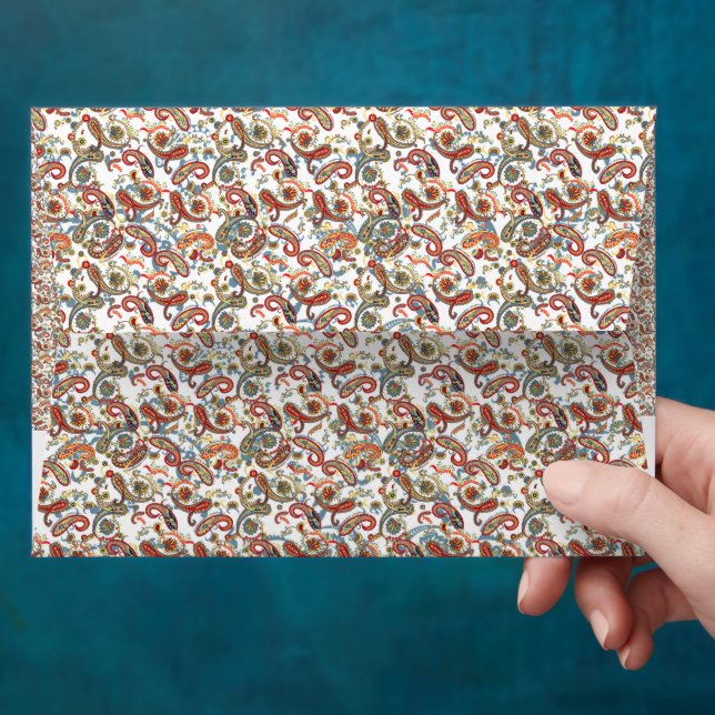 a black background with a red, green and blue patt envelope (Hand)