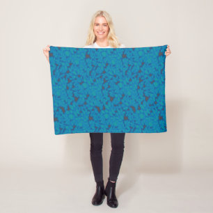 a blue and black background with a pattern fleece blanket