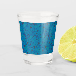 a blue and black background with a pattern shot glass