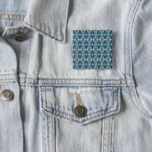a blue and green pattern with a white background 15 cm square badge