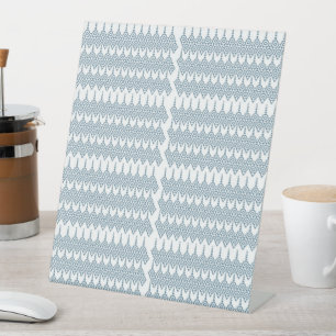 a blue and white pattern with a white background pedestal sign