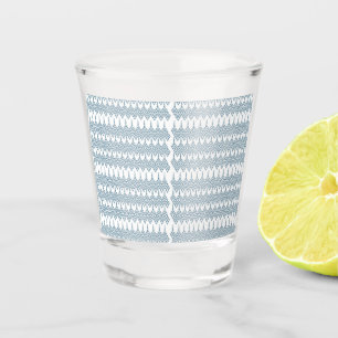 a blue and white pattern with a white background shot glass