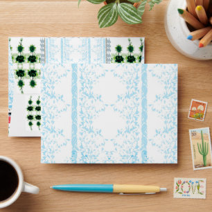 a blue and white striped background with leaves envelope