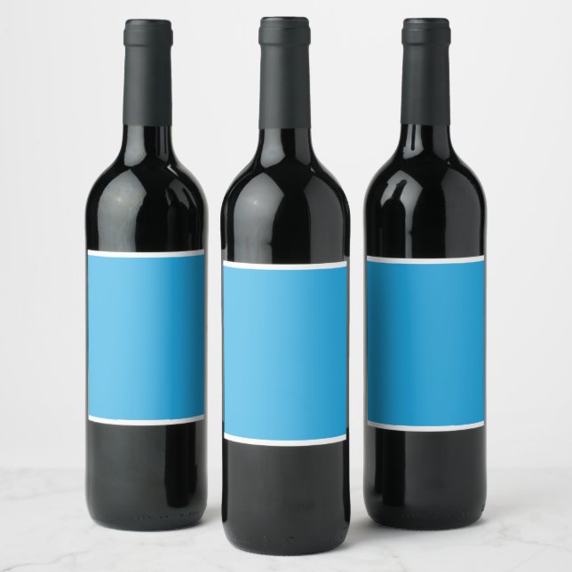 a blue background with a black and white cat wine label (Bottles)
