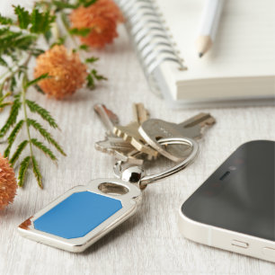 a blue background with a black and white clock key ring
