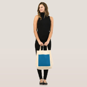 a blue background with a black and white clock tote bag