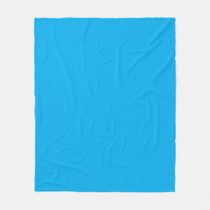 a blue sky with a plane flying in the sky fleece blanket