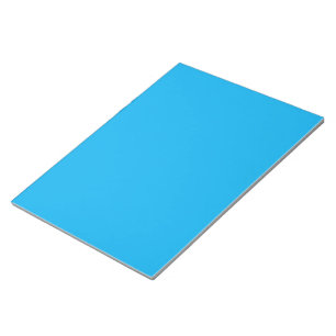 a blue sky with a plane flying in the sky notepad