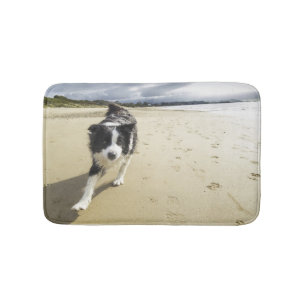 A Border Collie Dog Running On The Beach Bath Mat