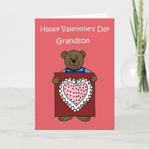 A boy bear holding a valentine holiday card