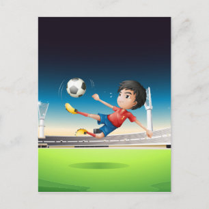 A boy in a red uniform at the soccer field postcard