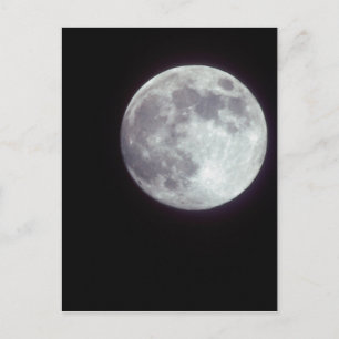 A bright full moon in a black night sky. postcard