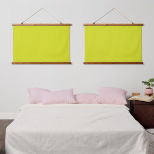 A bright yellow square with a distinct white borde hanging tapestry