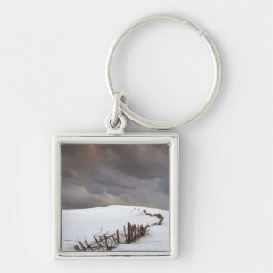 A Broken Fence Along A Snow Covered Field Key Ring