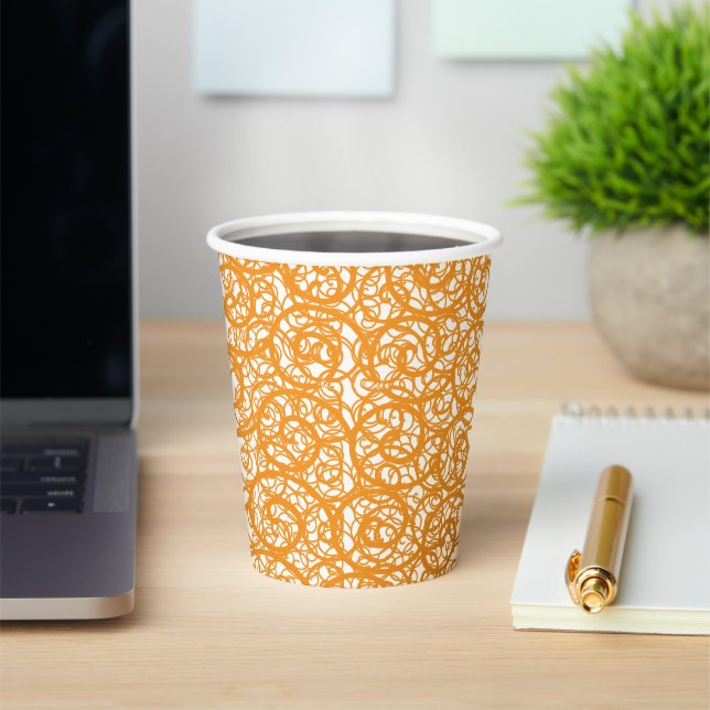 A brown and orange rug with a repeating pattern mo paper cups (Insitu)