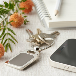 a brown wall with a black and white clock on it key ring