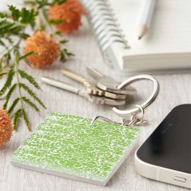 A brown wooden table holds a glass bottle of olive key ring (Front Right)