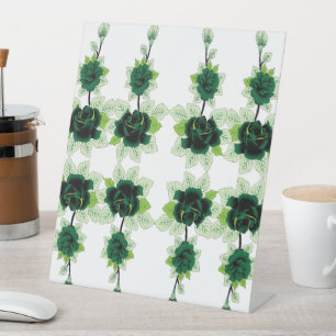 a bunch of green flowers on a white background pedestal sign