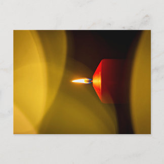A burning candle postcard