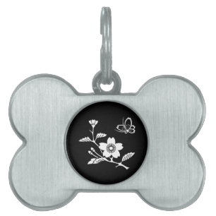 A butterfly in the middle of a cherry tree pet tag