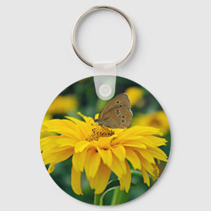 A butterfly on a yellow flower keychain