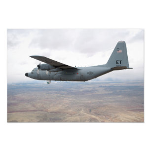 A C-130 Hercules soars through the sky Photo Print