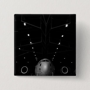 A C-17 Globemaster III sits in a hangar 15 Cm Square Badge