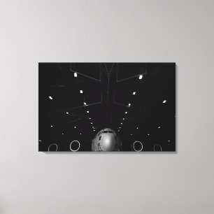 A C-17 Globemaster III sits in a hangar Canvas Print
