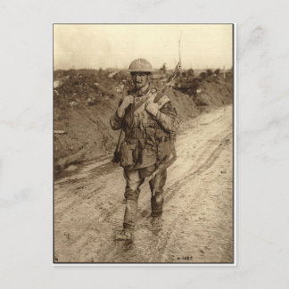 A Canadian Tommy soldier covered in mud returning Postcard