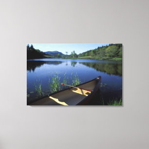 A canoe rests on the shore of Little Long Pond Canvas Print