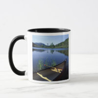 A canoe rests on the shore of Little Long Pond