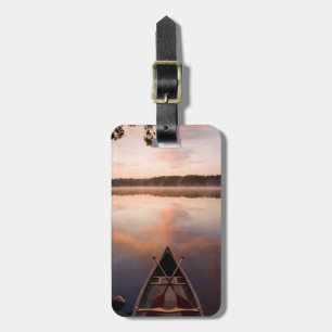 A canoe rests on the shore of Pawtuckaway Lake Luggage Tag
