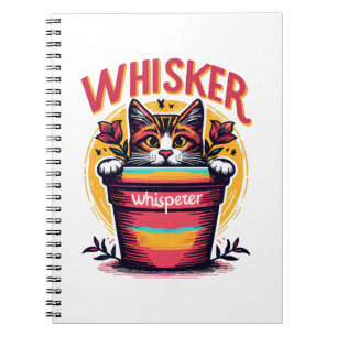 A cat peeking out from behind a flowerpot notebook