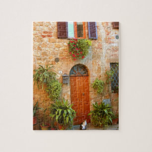 A cat seeks entrance to home in Pienza, Italy. Jigsaw Puzzle