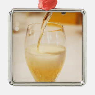 A champagne glass flute being filled with Gosset Metal Tree Decoration