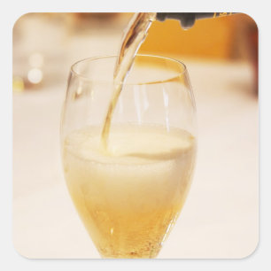 A champagne glass flute being filled with Gosset Square Sticker