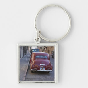 A classic old red Peugeot car parked on a street Key Ring