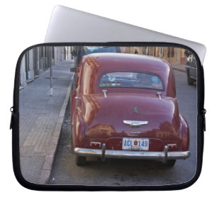 A classic old red Peugeot car parked on a street Laptop Sleeve