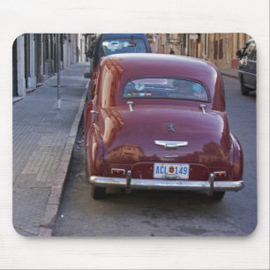 A classic old red Peugeot car parked on a street Mouse Mat