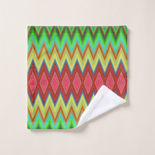A colorful, geometric-patterned towel set hangs