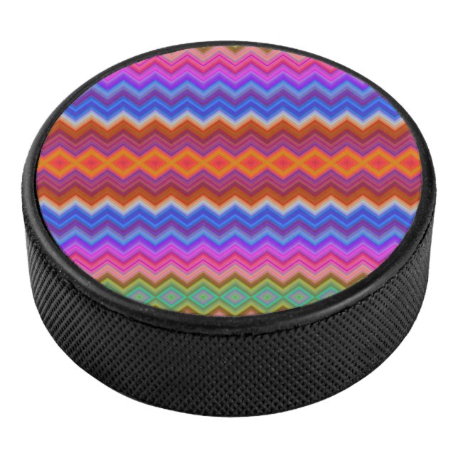 A colorful hockey puck features a vibrant zigzag  (3/4)